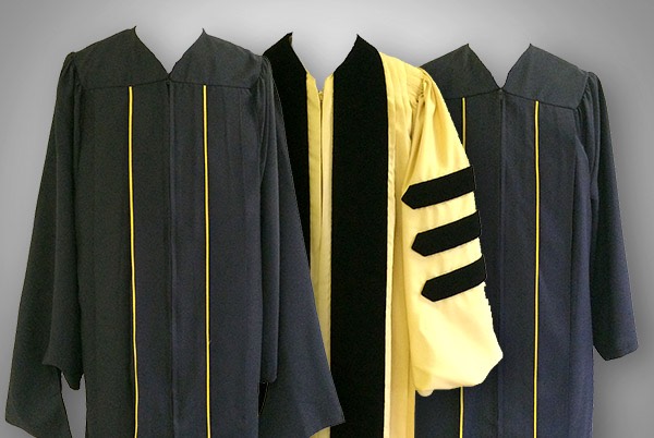 Three black and gold robes- 2 undergraduate, 1 doctoral.