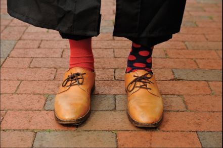 Photo of students' nice dress shoes and mismatched socks.